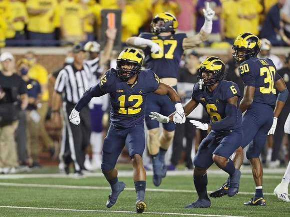 Josh Ross (12), Aidan Hutchinson (97), R.J. Moten (6), and Daxton Hill (30)