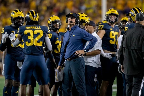 David Ojabo (55), Jaylen Harrell (32), Daxton Hill (30), Jim Harbaugh, and Aidan Hutchinson (97)