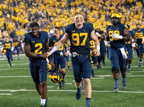 Brad Hawkins (2), Aidan Hutchinson (97), and Mazi Smith (58)