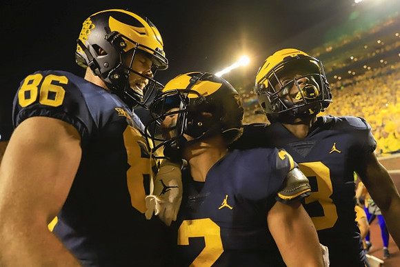 Luke Schoonmaker (86), Blake Corum (2), and A.J. Henning (3)