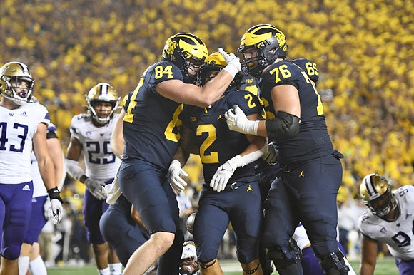 Joel Honigford (84), Blake Corum (2), Ryan Hayes (76), and Zak Zinter (65)