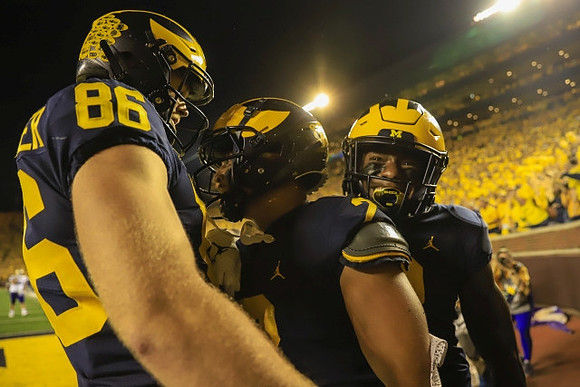 Luke Schoonmaker (86), Blake Corum (2), and A.J. Henning (3)