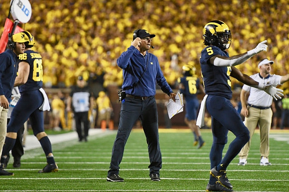 Luke Schoonmaker (86), Jim Harbaugh, and Mike Sainristil (5)