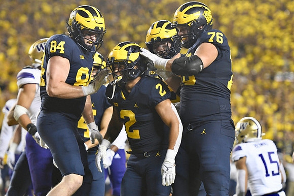 Joel Honigford (84), Blake Corum (2), and Ryan Hayes (76)