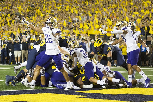 Zak Zinter (65), Ryan Hayes (76), and Hassan Haskins (25)