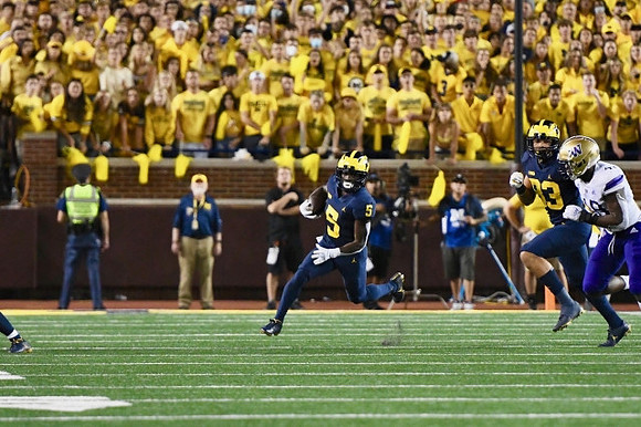 Mike Sainristil (5), and Erick All (83)