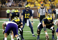 Hassan Haskins (25), Cade McNamara (12), and Andrew Vastardis (68)