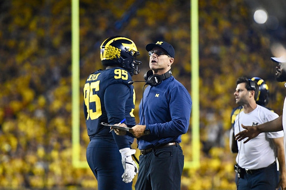Donovan Jeter (95), and Jim Harbaugh