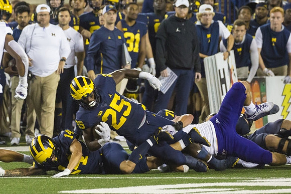Roman Wilson (14), and Hassan Haskins (25)