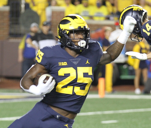 Hassan Haskins (25), and Roman Wilson (14)