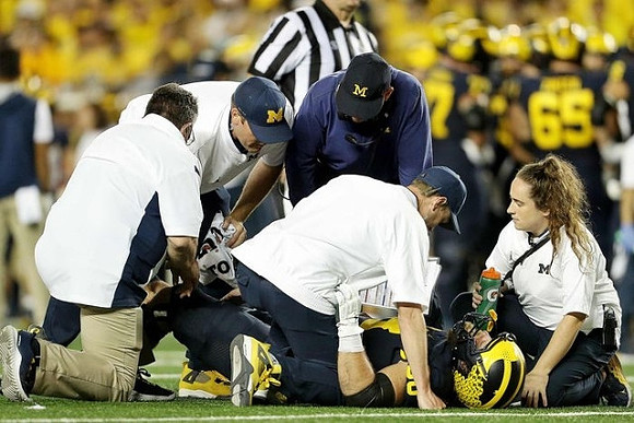 Chuck Filiaga (66), and Jim Harbaugh