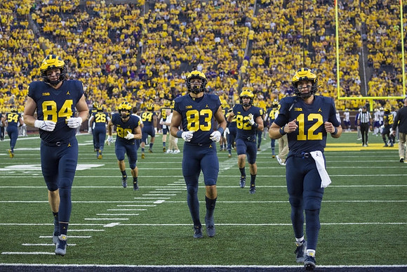 Joel Honigford (84), Erick All (83), and Cade McNamara (12)