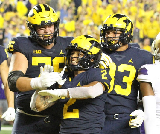 Ryan Hayes (76), Blake Corum (2), and Erick All (83)