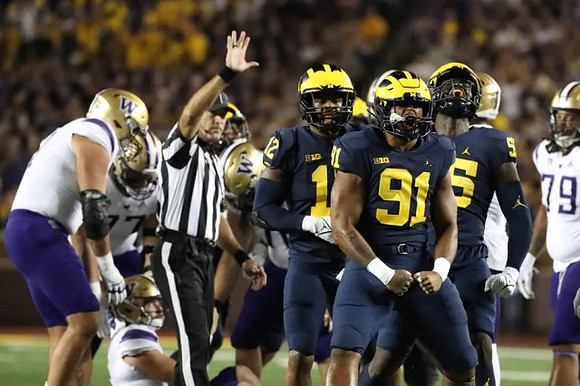 Josh Ross (12), Taylor Upshaw (91), and David Ojabo (55)