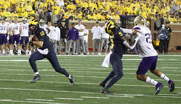 Blake Corum (2), and Mike Sainristil (5)