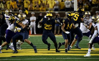 Erick All (83), Hassan Haskins (25), Roman Wilson (14), and Zak Zinter (65)