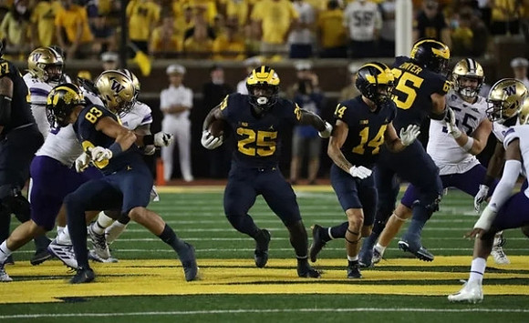 Erick All (83), Hassan Haskins (25), Roman Wilson (14), and Zak Zinter (65)