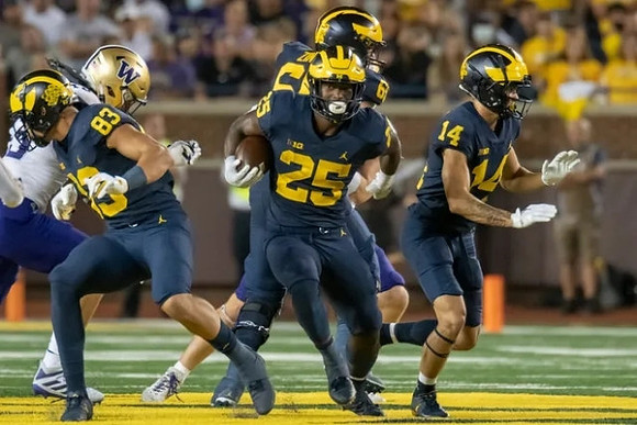 Erick All (83), Hassan Haskins (25), Zak Zinter (65), and Roman Wilson (14)
