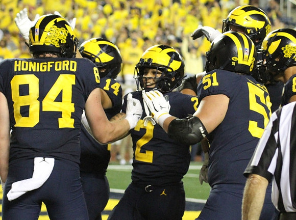 Joel Honigford (84), Roman Wilson (14), Blake Corum (2), and Greg Crippen (51)