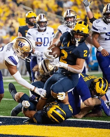 Erick All (83), Blake Corum (2), and Joel Honigford (84)