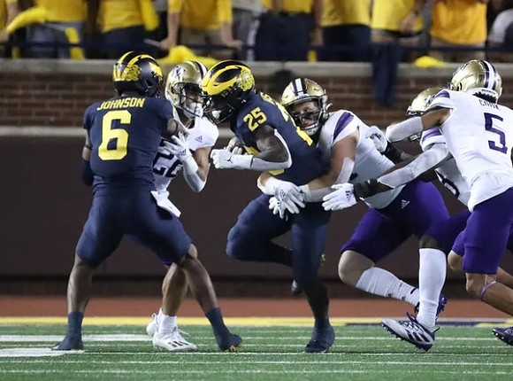 Cornelius Johnson (6), and Hassan Haskins (25)