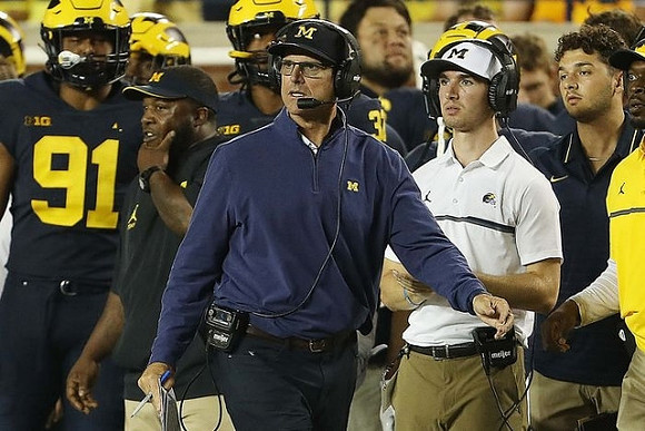 Taylor Upshaw (91), and Jim Harbaugh