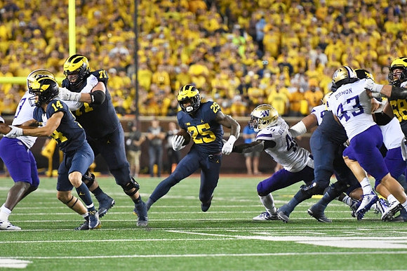 Roman Wilson (14), Andrew Stueber (71), Hassan Haskins (25), and Andrew Vastardis (68)