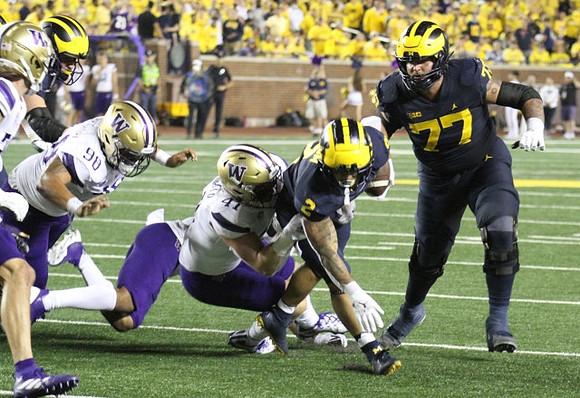 Blake Corum (2), and Trevor Keegan (77)