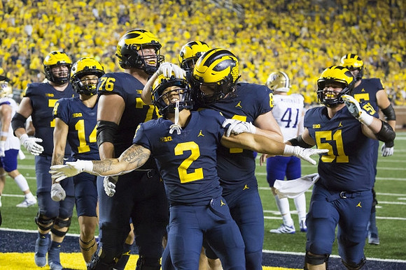 Roman Wilson (14), Ryan Hayes (76), Blake Corum (2), Joel Honigford (84), and Greg Crippen (51)