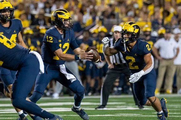 Cade McNamara (12), and Blake Corum (2)
