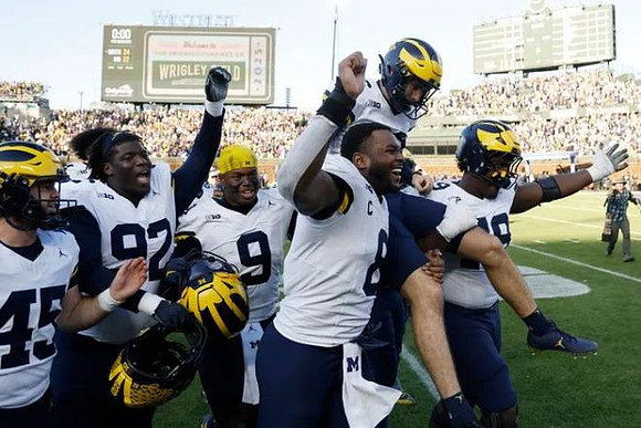 Dominic Zvada (96) and Michigan Team