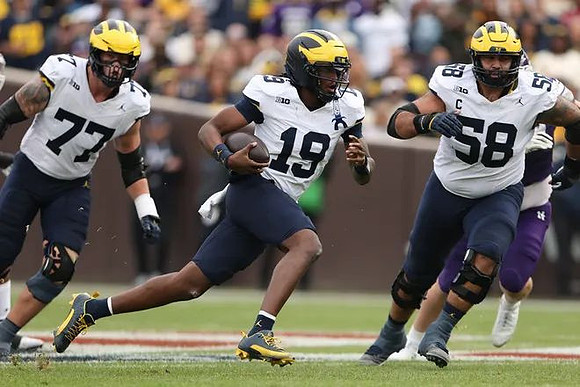 Blake Frazier (77), Bryce Underwood (19), and Giovanni El-Hadi (58)