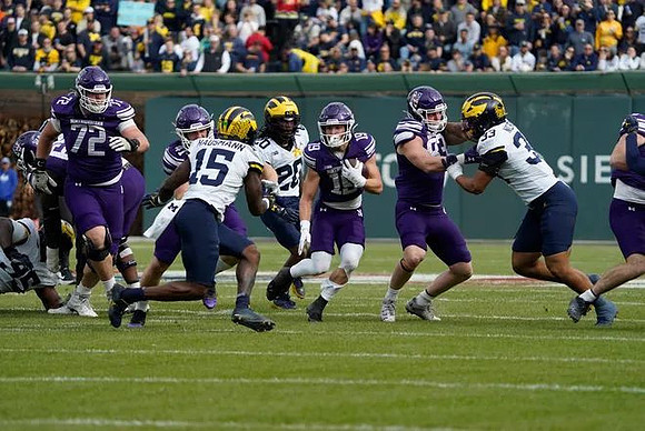 Trey Pierce (95), Ernest Hausmann (15), Jyaire Hill (20), and Dominic Nichols (33)