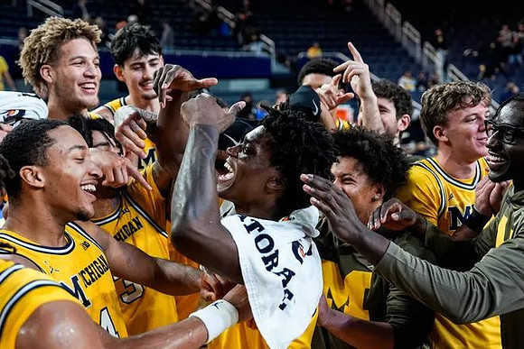 L.J. Cason (2) and Michigan Team