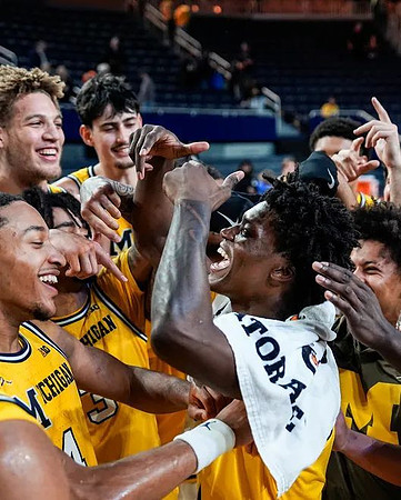 L.J. Cason (2) and Michigan Team