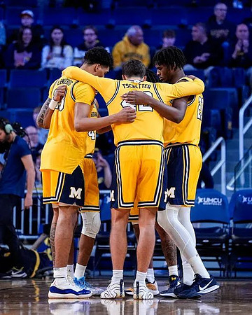 Yaxel Lendeborg (23), Will Tschetter (42), and Morez Johnson Jr. (21)