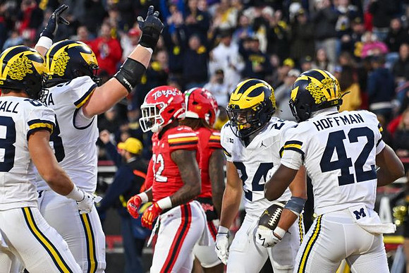 Zack Marshall (83), Jake Guarnera (53), Bryson Kuzdzal (24), and Jalen Hoffman (42)