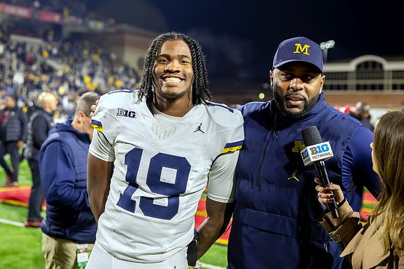 Bryce Underwood (19) and Sherrone Moore