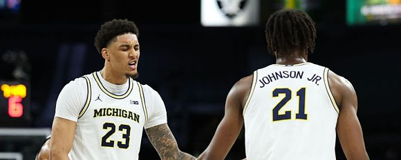 Yaxel Lendeborg (23) and Morez Johnson Jr. (21)