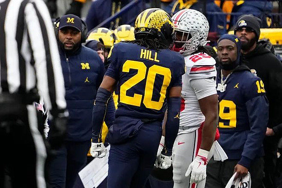 Sherrone Moore, Jyaire Hill (20), and Rod Moore (19)