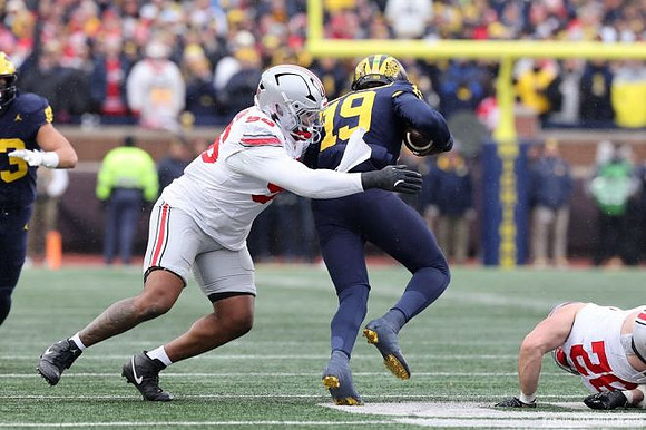 Jake Guarnera (53) and Bryce Underwood (19)