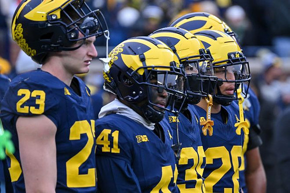 Cole Sullivan (23) and Michigan Team