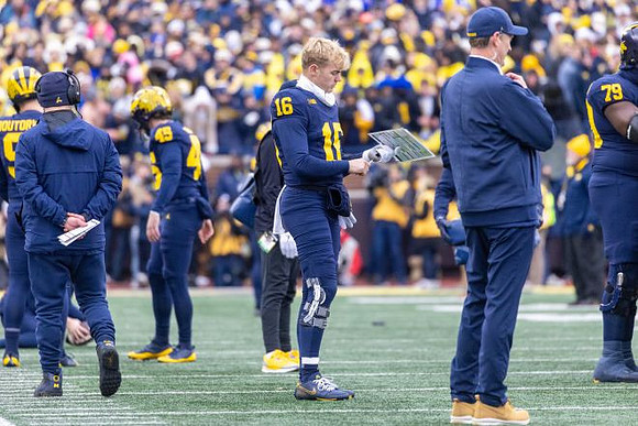 Davis Warren (16) and Michigan Team