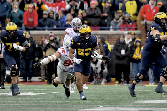 Blake Frazier (77), Jordan Marshall (23), and Andrew Sprague (54)