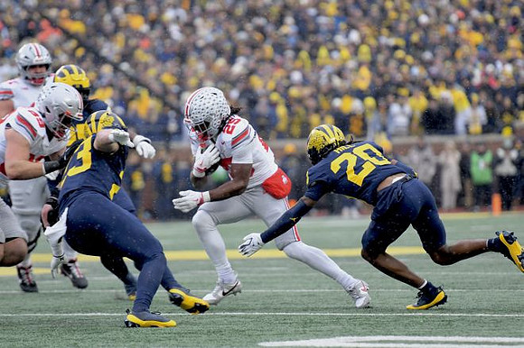 Cole Sullivan (23) and Jyaire Hill (20)