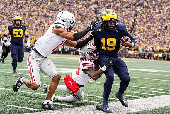 Jake Guarnera (53) and Bryce Underwood (19)