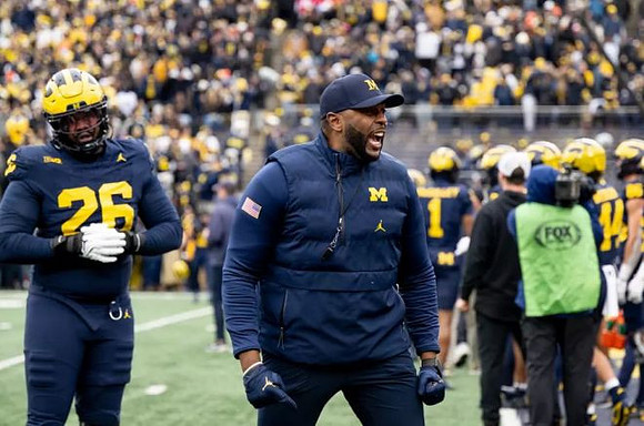 Rayshaun Benny (26) and Sherrone Moore