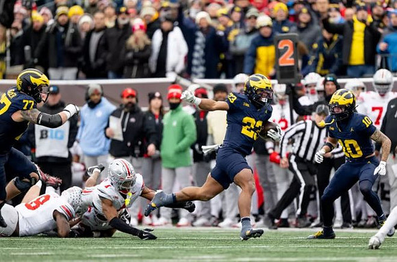 Blake Frazier (77), Jordan Marshall (23), and Kendrick Bell (10)