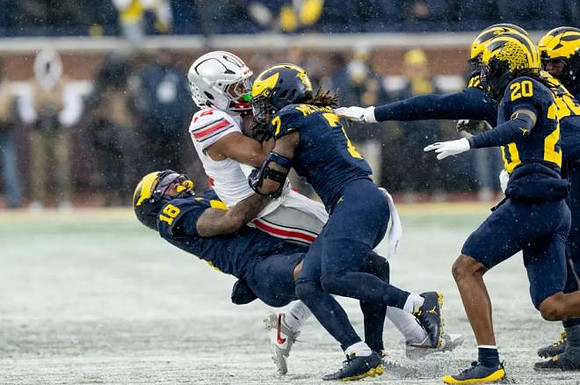 Troy Bowles (18), TJ Metcalf (7), and Jyaire Hill (20)