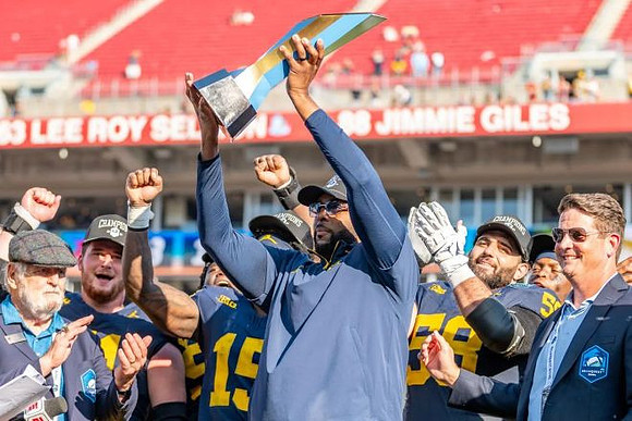 Sherrone Moore, Michigan Team, and ReliaQuest Bowl Trophy